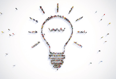 Co-Design at CHOIR overhead view of people standing in the shape of a lit-up lightbulb